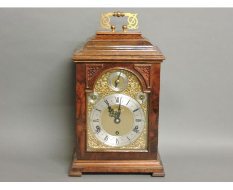 A good modern walnut bracket clock, by Elliott of London, with a three train musical movement striking on a nest of eight bel