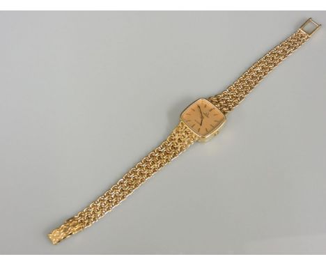 A ladies 9ct gold Omega quartz bracelet watch, with a cushion shaped champagne dial with raised gilt and black batons and han