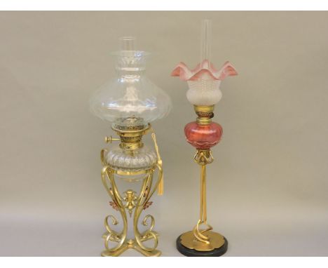 A Victorian oil lamp, with ornate brass stand, supporting a Hink's No 2 Duplex burner and a 'Tam o' Shanter' style glass shad