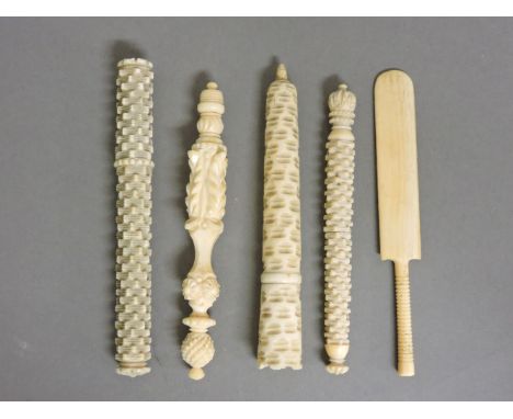 Four Victorian ivory needle cases, three with 'engine turned' decoration, and a miniature bone cricket bat