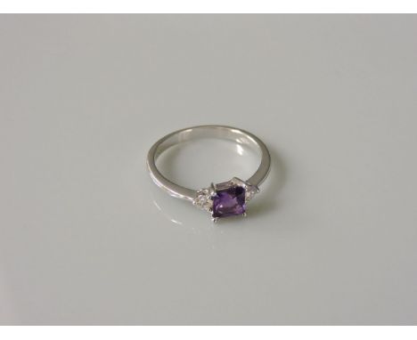 An 18ct white gold amethyst and diamond three stone ring