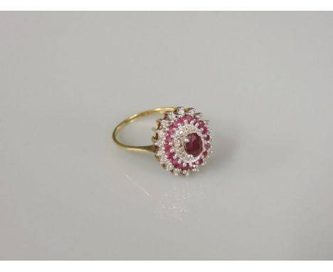 A 9ct gold ruby and diamond oval cluster ring