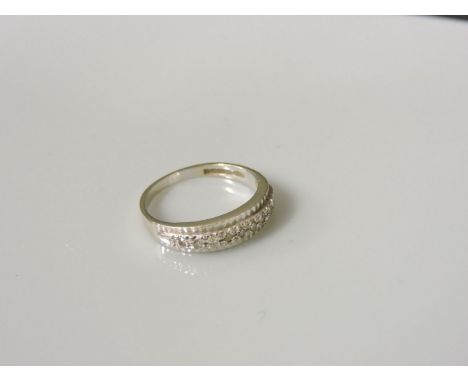 An 18ct white gold diamond set half eternity ring