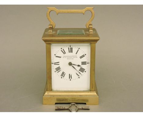 An Edwardian brass timepiece carriage clock, retailed by Bracher & Sydenham, To His Majesty the King, Reading, with an inscri