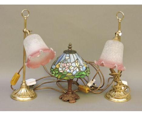 A Tiffany style leaded glass table and light, and a pair of adjustable brass table lights with pâte de verre style shades