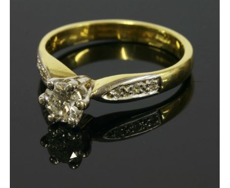 An 18ct gold single stone diamond ring, with diamond set shoulders, a brilliant cut diamond with an estimated weight of 0.63c