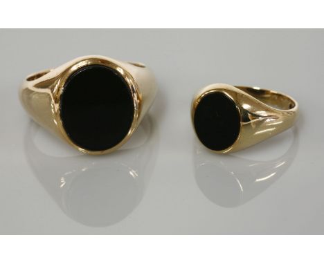 A gentleman's gold onyx set signet ring, marked 9ct, and a ladies 9ct gold onyx signet ring