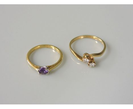 An 18ct gold single stone amethyst ring, and a 9ct gold two stone diamond crossover ring