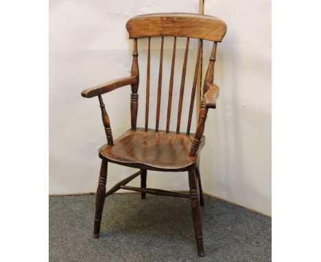 An oak and elm Windsor style stick back chair, on ring turned supports and 'H' stretcher