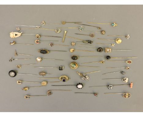 A collection of stick pins, including gold and cameo examples