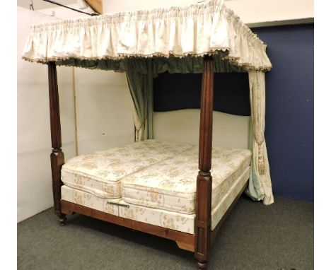 A four poster bed, with columns, covered in turquoise fabric, with curtains, and two 3ft divan bases with mattresses, 220cm h
