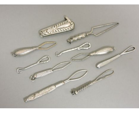 A collection of white metal mounted sewing tools