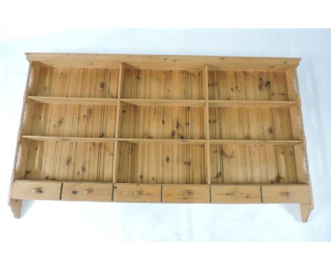 A pine hanging board rack of shelves, with drawers below, 212cm wide, another hanging shelf, and two mirrors