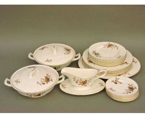 A Royal Worcester six place dinner service, with tureens, meat plate, and gravy boat with stand
