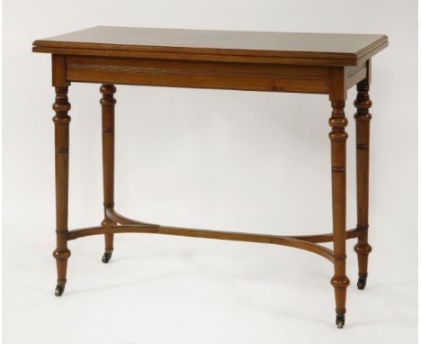 An Edwardian walnut fold over card table