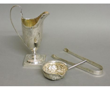 A Georgian silver helmet shaped cream jug, by TS London 1986, 15cm high, a pair of silver sugar tongs, by Peter and Ann Batem