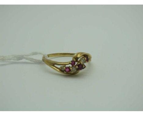 A Modern 9ct Gold Ruby and Diamond Set Dress Ring, of crossover style, claw set (finger size T) (2.3grams). [2010397]