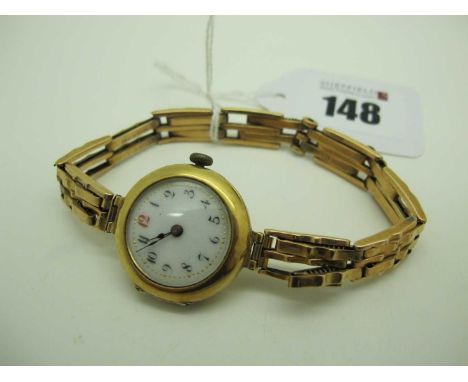 A Vintage 18ct Gold Cased Ladies Wristwatch, the white enamel dial with black and red Arabic numerals, within plain case (imp