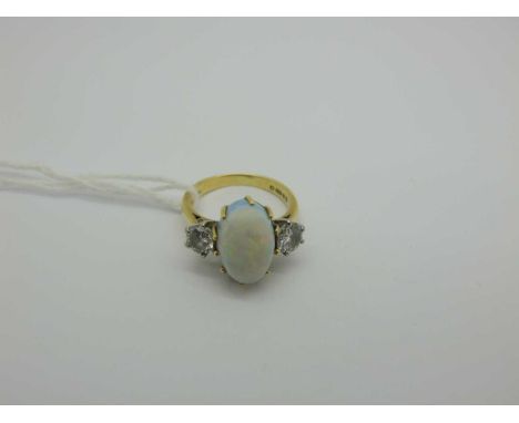 An 18ct Gold Opal and Diamond Dress Ring, cabochon claw set centre, within brilliant cut highlights, between tapered shoulder