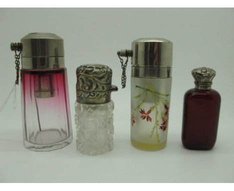 A Hallmarked Silver Topped Cut Glass Bottle, the hinged lid detailed in relief, with internal stopper; together with a ruby c