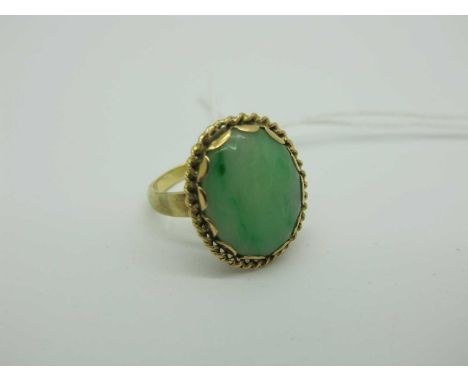 A Modern Oval Polished Hardstone Ring, within rope twist border, between plain shoulders, stamped "18ct" (finger size N) (5 g