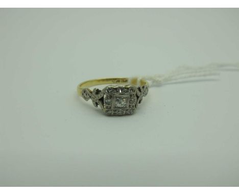 A Victorian Style Diamond Set Cluster Ring, the old cut stones within rectangular setting, between decorative shoulders, stam