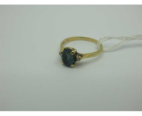 A Modern Claw Set Ring, oval centre, between claw set highlights, stamped "14K" "585" (finger size P) (2 grams).