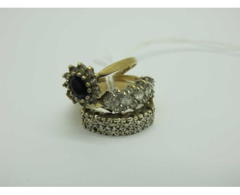 A 9ct Gold Cluster Ring, of flowerhead design, claw set throughout, between plain shoulders (finger size P), a 9ct gold dress