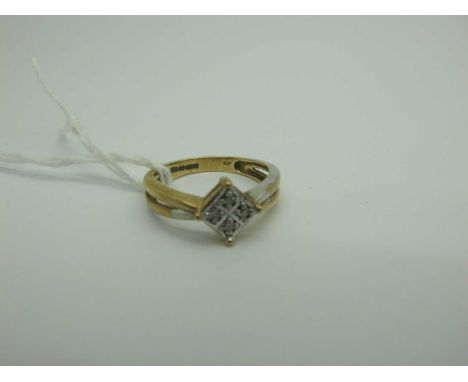 A 9ct Two Colour Gold Diamond Set Ring, of square design illusion set, betweel bifurcated shoulders, stamped ".05" (finger si