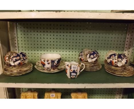 SHELF OF UNMARKED PATTERNED TEA WARE