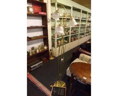 A MODERN BRASS STANDARD LAMP WITH THREE LIGHTS &amp; SHADES