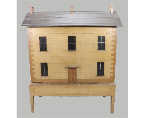 A fine and early English painted wooden dolls house on original stand, 1820s/30s, the painted sand stone façade and sides wit