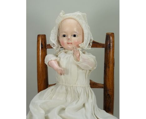 A wax over composition Mochmann baby with squeaker, German mid 19th century, with black enamel eyes, single stroke brows, pai