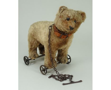 Brown mohair bear on wheels, probably Steiff, circa 1909, with black boot button eyes, clipped muzzle with black stitched nos