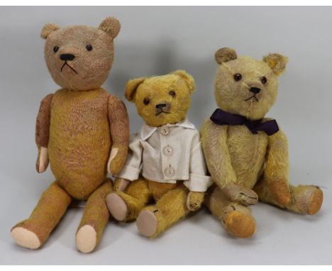 Three golden mohair Teddy bears, two with orange glass eyes black stitched nose, mouth and claws, swivel heads and jointed at