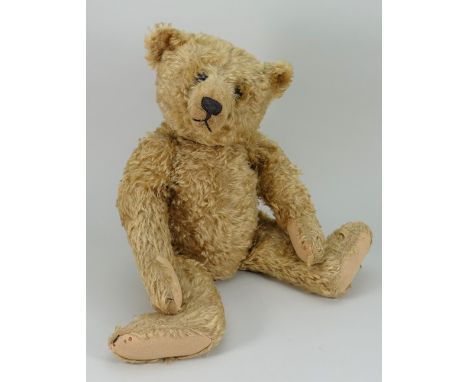 A good Steiff centre seam golden mohair Teddy bear, circa 1909, the straw filled bear with long golden mohair, boot button ey