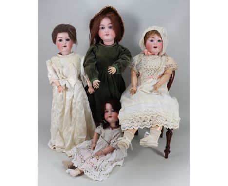 Four bisque headed dolls, including an A.M 390 girl doll with weighted blue glass eyes, open mouth with teeth, brown wig and 