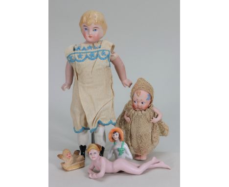 A bisque shoulder head doll, German circa 1900, with painted blue eyes, closed mouth and moulded blonde hair, on a cloth body