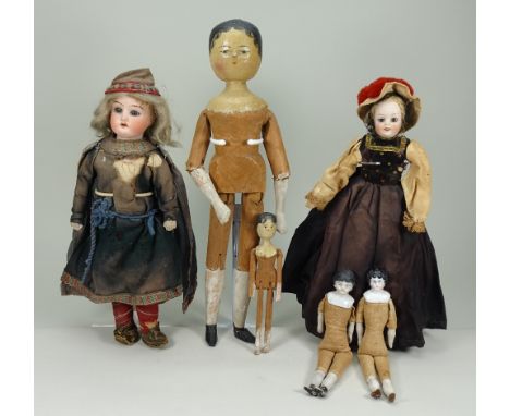 Large painted wooden peg doll, circa 1890, with painted features and short black hair style, jointed at shoulders, elbows, hi