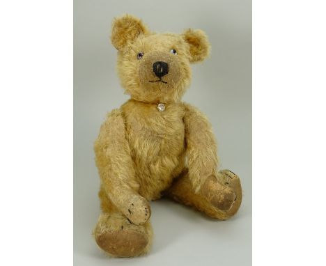 A Chad Valley golden mohair Teddy bear with button, circa 1930, the straw filled bear with glass eyes, clipped snout with sti