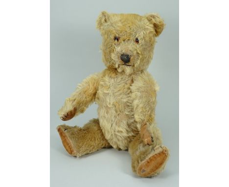 A golden mohair Chiltern musical Hugmee Teddy bear, 1950s, kapok and straw filled bear with orange glass eyes, vertically sti