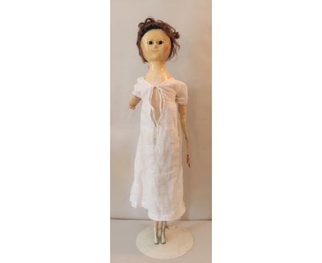 A fine George III  early English painted wooden doll, circa 1775, the painted gesso face with black enamel pupil-less eyes, p