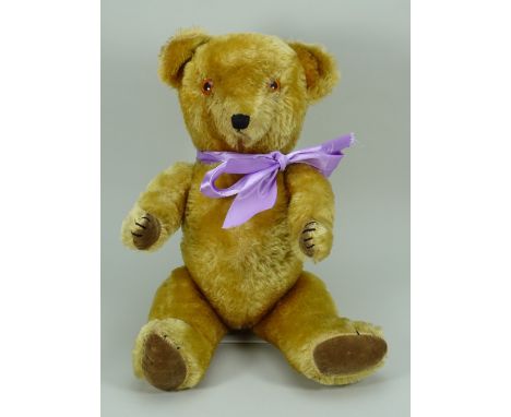 A Chiltern golden mohair Teddy bear, circa 1960, the kapok filled bear with orange plastic eyes, stitched nose, mouth and cla