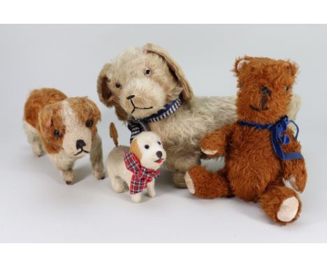 Three soft toy dogs, English 1930s-50s, including a cream and brown terrier type with black button eyes, stitched nose and mo