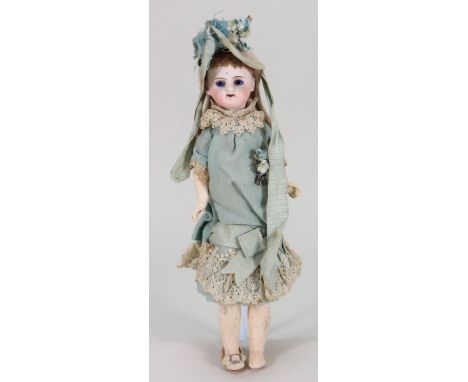A small bisque head doll in original clothes, French circa 1890, pale bisque head with fixed blue glass eyes, single stroke b