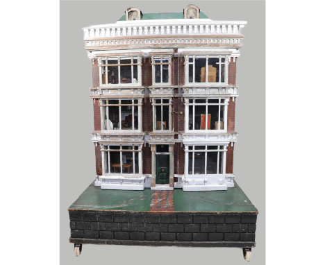 ‘Hartley Hall’ an imposing double fronted painted wooden dolls house, English circa 1875, the façade and sides painted in red