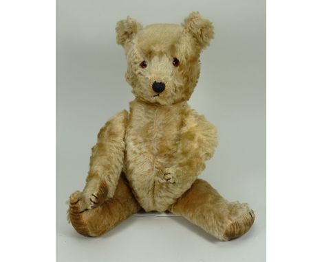 A Chiltern ‘Hugmee’ Teddy bear, English 1930s, the light brown mohair bear with amber and black glass eyes, black stitched no