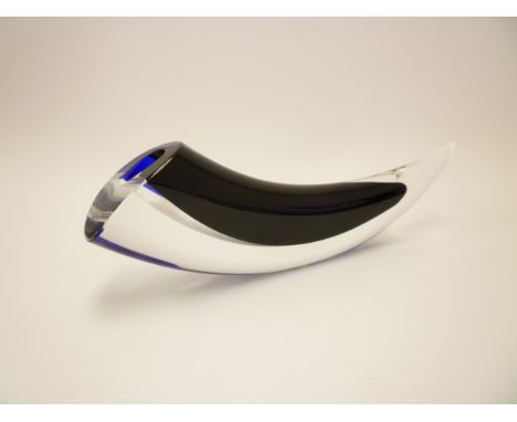 A Kosta Boda glass sculpture 'Horn' by Goran Warff in blue and black, encased in clear. Etched marks to base. 28cm long x 8cm