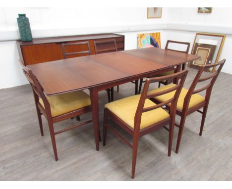 A mid century Richard Hornby extending dining table and six matching chairs. Seats reupholstered and meet 1988 regulations. T