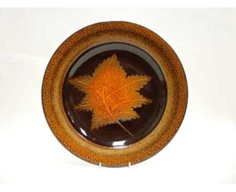 A Poole Pottery Aegean Charger depicting a Maple leaf. 39cm diameter 